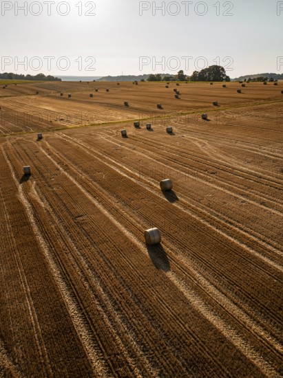 Panorama of fields with straw bales under the sun in a rural setting, Gechingen, district of Calw, Germany