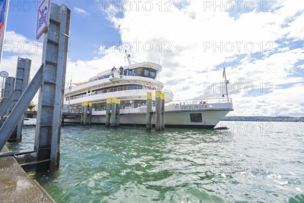 A ship moored at the harbour of Überlingen under a cloudy sky, Lake Constance, Germany