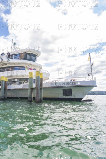 A ship is anchored in the harbour of Überlingen in the sunshine, Lake Constance, Germany