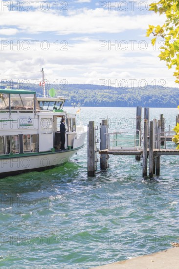 Boat at the pier on a lake under a cloudy sky, Lake Constance, Germany