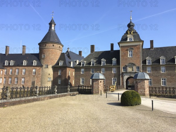 View of entrance portal and towers of moated castle moated castle Schloss Anholt, Isselburg, North Rhine-Westphalia, Germany