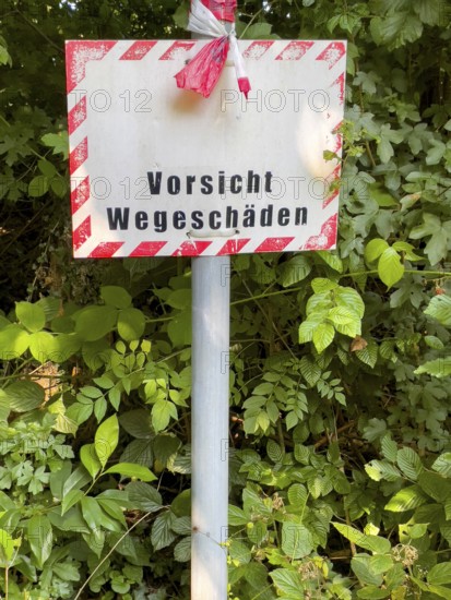Warning sign indicating road damage, Essen, North Rhine-Westphalia, Germany