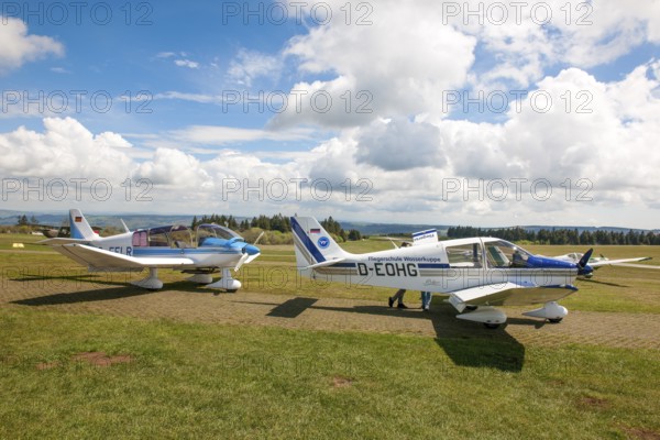 View of two single-engine cantilever low-wing propeller aircraft Light aircraft left type Robin DR.400-180R Remorqueur towing aircraft for glider pilots, right Robin DR400-180 Regent suitable as towing aircraft for glider pilots in parking position on apron of Wasserkuppe airfield, Gersfeld, district of Fulda, Hesse, Germany