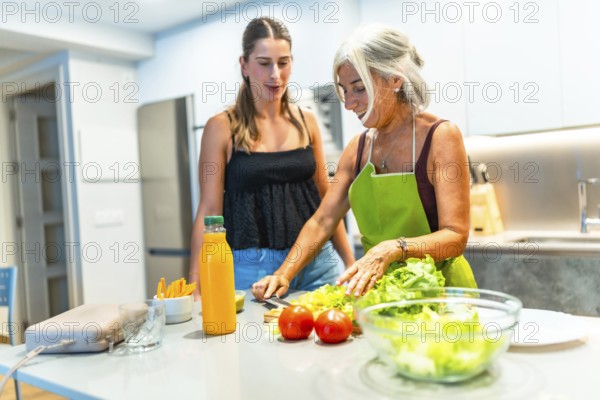 Mother and daughter preparing a healthy salad together in a modern kitchen, enjoying quality time and promoting healthy eating habits