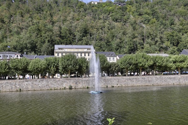 Bad Ems, Lahn riverside promenade with fountain and spa gardens, Rhineland-Palatinate, Germany