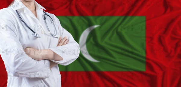 Doctor with crossed arms on Maldives flag. Maldivian health and care concept. Female doctor on Maldives flag