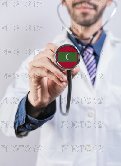 Maldives health and medical insurance concept. Maldives healthcare system, doctor holding stethoscope