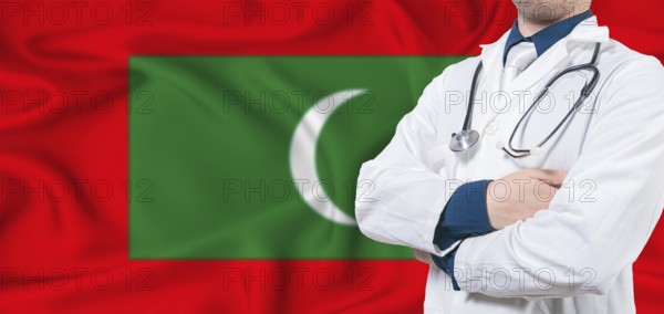 Maldives healthcare concept. Male doctor on Maldives flag. Doctor with crossed arms on Maldives flag
