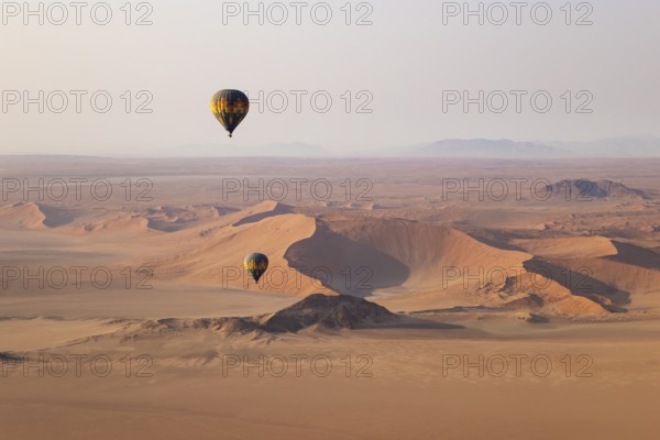 Two hot-air balloons at the edge of the Namib Desert. Aerial view from another balloon. Namibia
