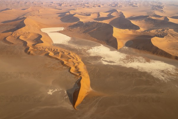Sand dunes and dry pans in the Namib Desert. In the evening. Aerial view. Namib-Naukluft Park, Namibia