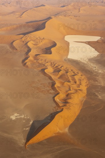 Sand dunes and dry pans in the Namib Desert. In the evening. Aerial view. Namib-Naukluft Park, Namibia