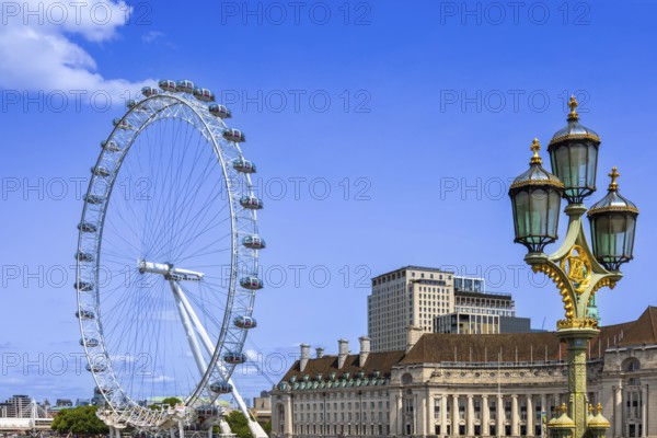 Travel attraction of London Eye Millenium ferris wheel overlooking London Big Ben and British Parliament