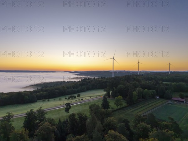 Expansive landscape with wind turbines and a veil of mist at dawn, near Schorndorf, Rems-Murr district, Rems-Murr-Kreis, Baden-Württemberg, Germany