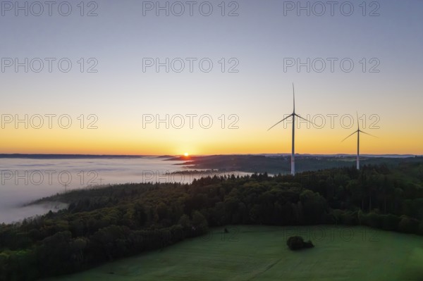 Sunrise over a foggy landscape with visible wind turbines, near Schorndorf, Remstal, Rems-Murr-Kreis, Baden-Württemberg, Germany