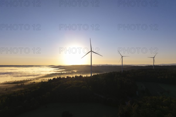 A wind turbine stands prominently in the morning fog under a clear sky, near Schorndorf, Remstal, Rems-Murr-Kreis, Baden-Württemberg, Germany