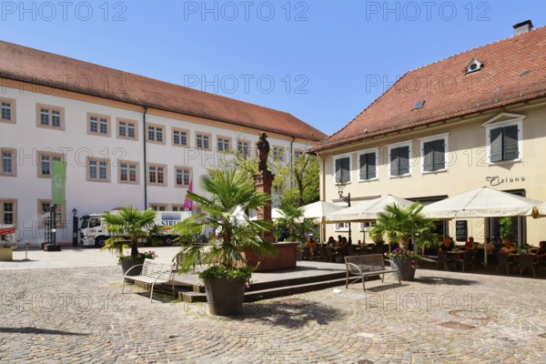 Ettlingen, Germany - August 13th 2025: Fountain at Ettlingen Schlosplatz town square on a sunny day in Germany