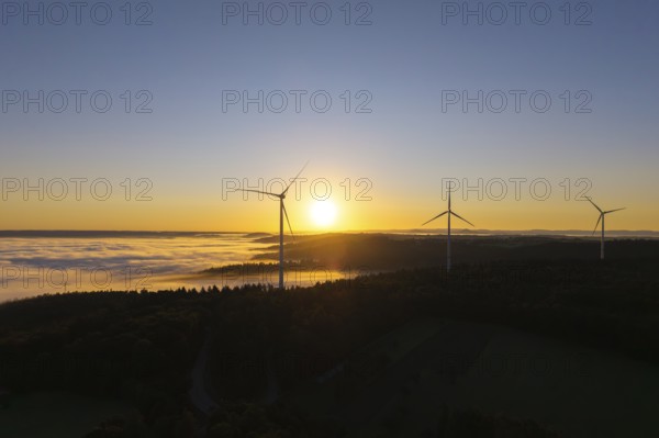 Wind turbines above a misty landscape at sunrise, near Schorndorf, Rems-Murr district, Rems-Murr-Kreis, Baden-Württemberg, Germany