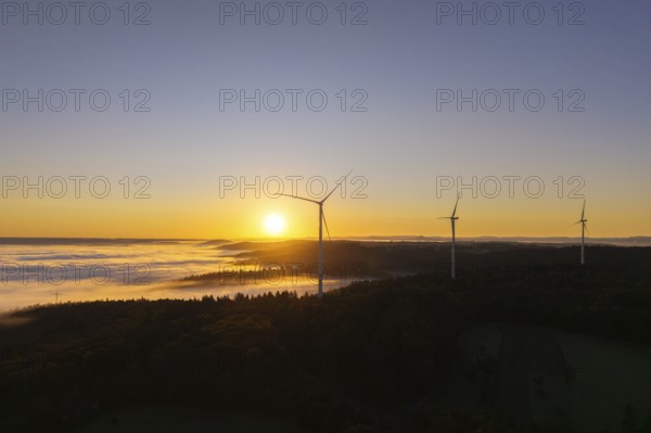 Three wind turbines towering in the morning landscape with fog, near Schorndorf, Rems-Murr-Kreis, Rems-Murr-Kreis, Baden-Württemberg, Germany