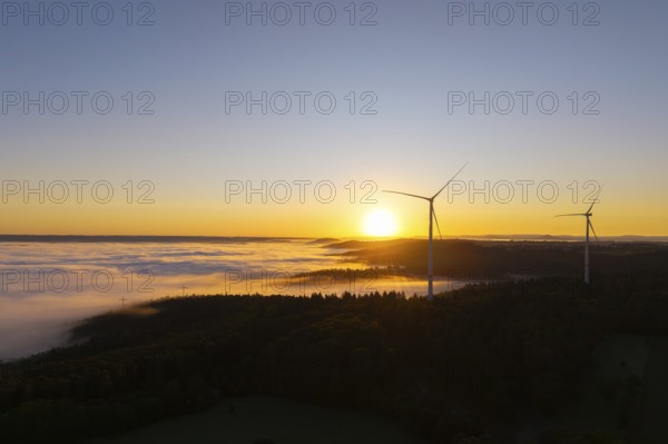 Wind turbines over foggy fields and hills at sunrise, near Schorndorf, Rems-Murr-Kreis, Rems-Murr-Kreis, Baden-Württemberg, Germany