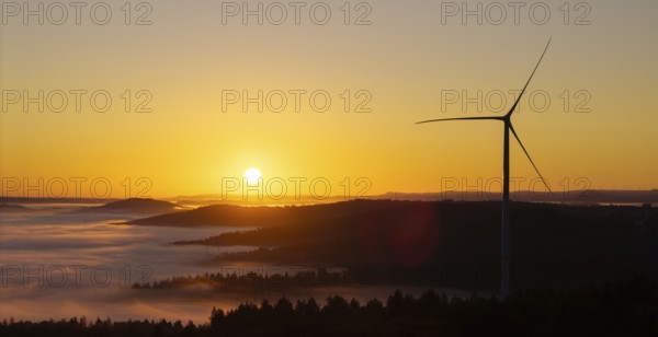 Wind turbine in front of a picturesque sunrise over a misty landscape, near Schorndorf, Remstal, Rems-Murr-Kreis, Baden-Württemberg, Germany
