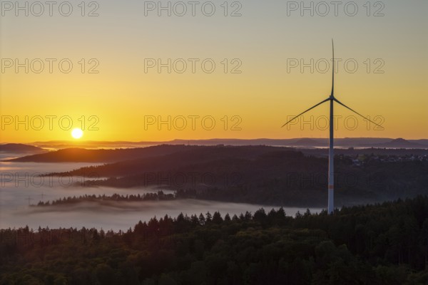 Wind turbine at sunrise over a misty hilly landscape, near Schorndorf, Rems-Murr district, Rems-Murr-Kreis, Baden-Württemberg, Germany