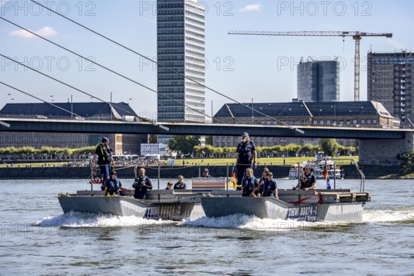 Exercise drive of a multi-purpose pontoon on the Rhine, of the specialist group for water hazards, in Düsseldorf, the motorised pontoon can be used as a ferry for people or equipment, as a working platform or bridge, during the major exercise FÜLEX25, lasting several days, of the THW, Technisches Hilfswerk, Landesverband North Rhine-Westphalia, on 4 weekends over 3500 volunteers from the 127 North Rhine-Westphalia local associations practise many different operational scenarios