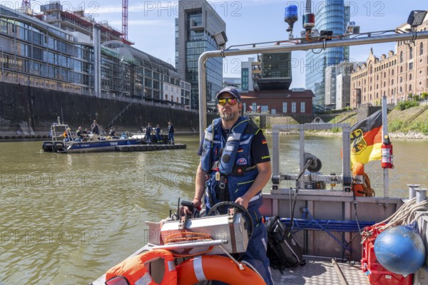 Multi-purpose boat of the THW during a training trip on the Rhine, Medienhafen in Düsseldorf, of the specialist group for water hazards, this type of boat is used to transport people and goods as a rescue boat and as a working platform, during the major exercise FÜLEX25, lasting several days, of the THW, Technisches Hilfswerk, Landesverband North Rhine-Westphalia, on 4 weekends over 3500 volunteers from the 127 North Rhine-Westphalia local associations practise many different deployment scenarios