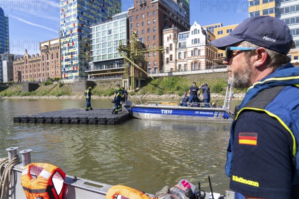 Transport of a floating platform with the jet-float system, this can be used as a work platform, jetty or bridge, water hazards specialist group, multi-purpose boat accompanied, in Düsseldorf, at the major exercise FÜLEX25, lasting several days, of the THW, Federal Agency for Technical Relief, North Rhine-Westphalia, over 3500 volunteers from the 127 North Rhine-Westphalia local associations practise many different deployment scenarios over 4 weekends