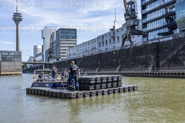 Transport of a floating platform with the jet-float system, this can be used as a work platform, jetty or bridge, specialist group for water hazards, in Düsseldorf, during the major exercise FÜLEX25, lasting several days, of the THW, Federal Agency for Technical Relief, North Rhine-Westphalia, over 3500 volunteers from the 127 North Rhine-Westphalia local organisations practise many different deployment scenarios over 4 weekends