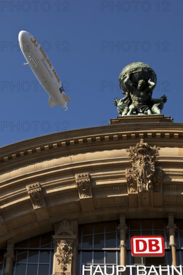 Main front of the main railway station with Atlas carrying the globe on his shoulders and a zeppelin, Frankfurt am Main, Hesse, Germany