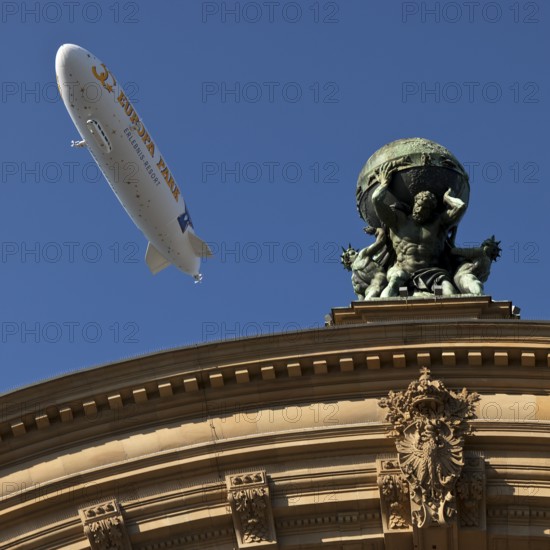 Main front of the main railway station with Atlas carrying the globe on his shoulders and a zeppelin, Frankfurt am Main, Hesse, Germany