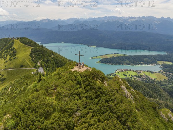 Panoramic view over a mountain and lake landscape with a cross on the summit, Herzogstand summit, Walchensee, Schlehdorf, Germany