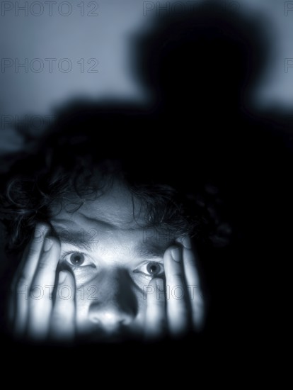 A close-up of a man whose face is marked by fear, symbolising anxiety disorders, panic attacks, mental illness, AI generated, AI generated