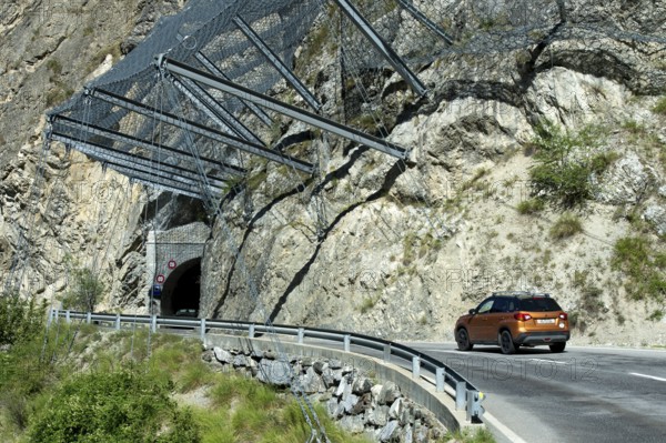 Safety nets on the rock face at the exit of the Petits Pontis tunnel protect road traffic on the cantonal road against falling rocks, Val d'Anniviers, Valais, Switzerland