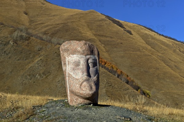 Stone sculpture of a male head, open-air exhibition Stone Heads of Sno by sculptor Merab Piranishvili, mountain village of Sno, Kazbegi municipality in the Mtskheta-Mtianeti region, Georgia