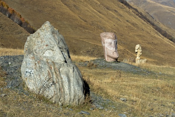 Stone sculptures in the open-air exhibition Stone Heads of Sno by sculptor Merab Piranishvili, mountain village of Sno, Kazbegi municipality in the Mtskheta-Mtianeti region, Georgia