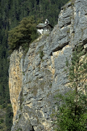 The small Chapelles des Pontis chapel on a rocky outcrop on the precipice, Chandolin, Val d'Anniviers, Valais, Switzerland