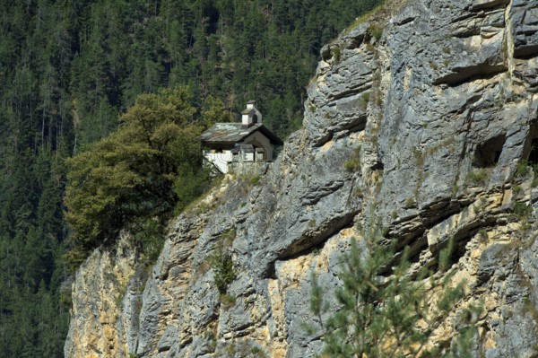 The small Chapelles des Pontis chapel on a rocky outcrop on the precipice, Chandolin, Val d'Anniviers, Valais, Switzerland