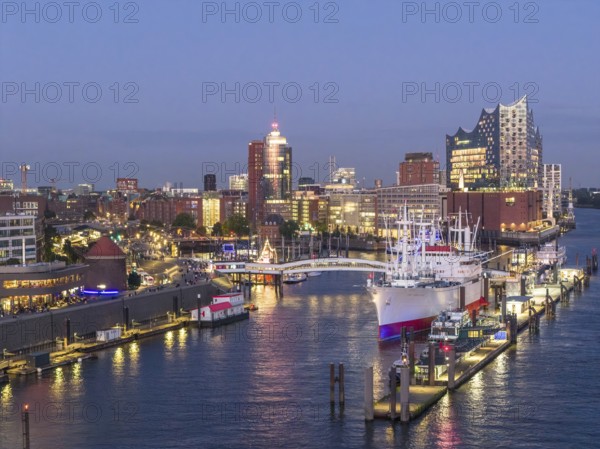 Aerial view of the Landungsbrücken Hamburg (Jan-Fedder-Promenade) at blue hour with Elbe, Cap San Diego and Elbphilharmonie in the background, Hamburg, Germany