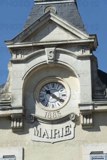 This French city hall features an elegant clock tower with a classic face, highlighting the intricate architectural design. The structure is a symbol of local governance and heritage