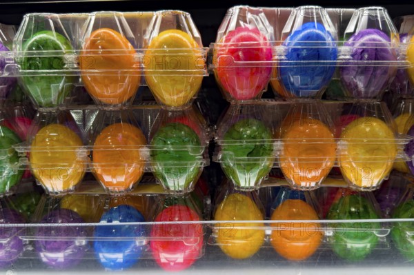 Colourful dyed hard-boiled eggs Easter eggs in plastic blister packs for year-round retail sale, Germany