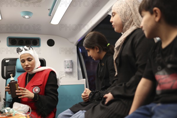 Syrian Arab Red Crescent volunteers conduct first aid training for children during the Damascus International Fair, the first edition held after the fall of Bashar al-Assad. The activity raises awareness of health, safety, and emergency preparedness among young visitors, Damascus, Damascus, Syria