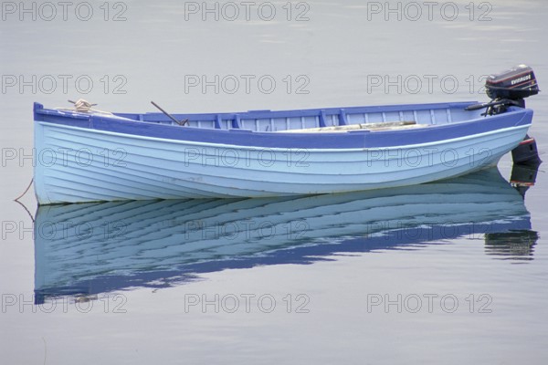 Fishing boat reflected on the lake, England, Great Britain