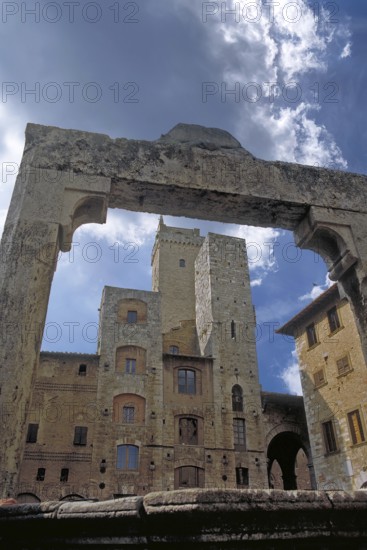 View through the fountain arch to the towers, market square, San Gimignano, Tuscany, Italy