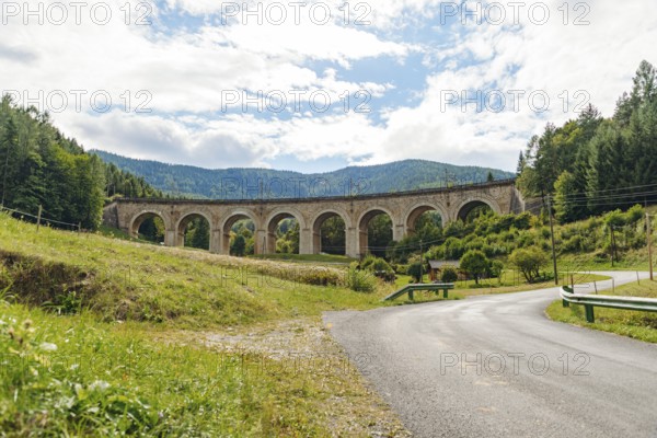 Adlitzgraben Viaduct, cloudy sky and green hills, Semmering Railway, Semmering, Lower Austria, Austria
