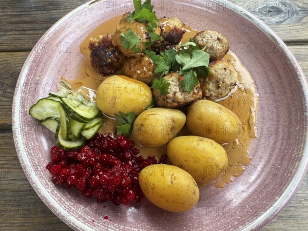 Traditional Swedish dish: Meatballs with potatoes and lingonberries on a plate in Ystad, Skåne County, Sweden, Scandinavia