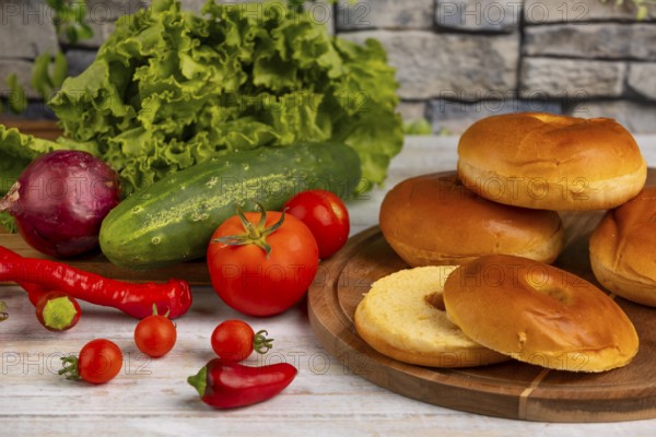 A selection of fresh ingredients such as tomatoes, cucumber, lettuce and bagels