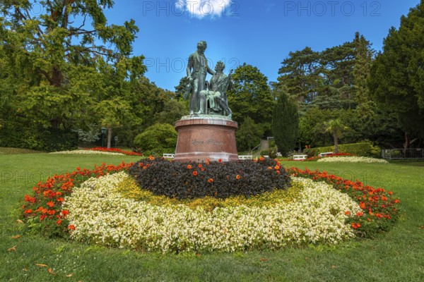 Lanner-Strauss monument surrounded by flowers and trees in the spa garden Baden, Lower Austria, Austria