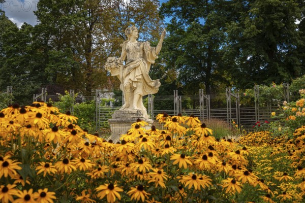 Statue of the goddess Flora surrounded by yellow coneflower (Echinacea), Doblhoffpark, Baden, Lower Austria, Austria