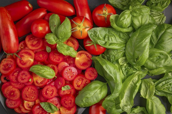 Sliced and whole tomatoes with fresh basil